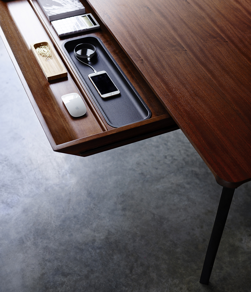 Herman Miller desk with open drawer showing the internal features and compartments of the drawer
